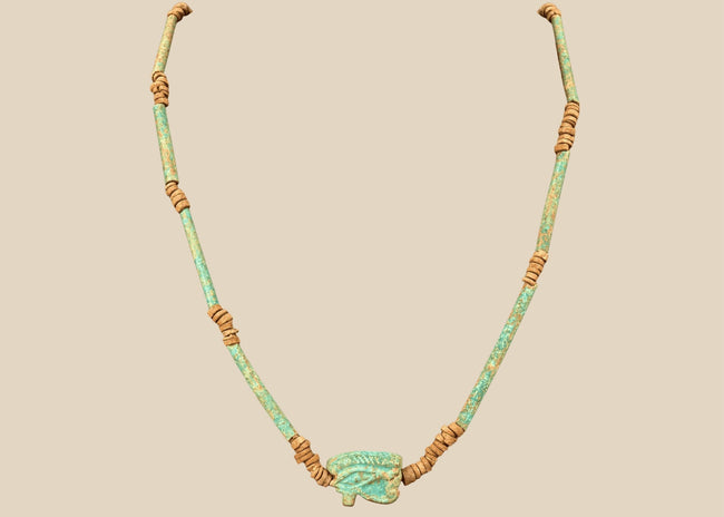 Ancient Egyptian Eye of Horus faience necklace with turquoise-green tubular beads and earthy brown spacer beads, circa 664–30 BCE.