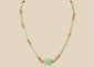 Ancient Egyptian Eye of Horus faience necklace with turquoise-green tubular beads and earthy brown spacer beads, circa 664–30 BCE.