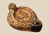 Ancient Roman terracotta oil lamp with ithyphallic male figure in central relief, circa 2nd century CE, featuring elaborate moulded decoration.