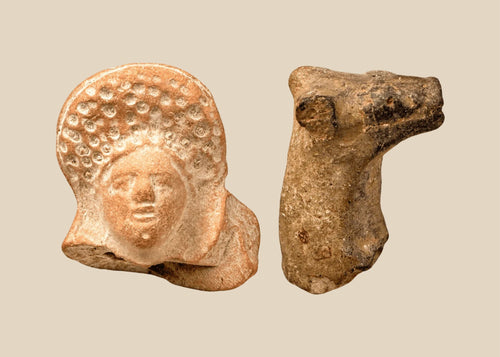 Ancient Roman terracotta female head with elaborate curled coiffure alongside an Early Bronze Age Mesopotamian bovine protome.