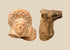 Ancient Roman terracotta female head with elaborate curled coiffure alongside an Early Bronze Age Mesopotamian bovine protome.