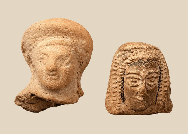 Pair of ancient terracotta female head fragments attributed to Etruscan and East Greek artistic traditions, circa 550–300 BCE.