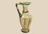 Ancient Roman–Byzantine blown glass jug from the Eastern Mediterranean, circa 4th–5th century CE, featuring vertical ribbing and blue-green glass decoration.