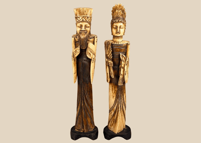 Vintage Chinese carved-bone Emperor and Empress figurines, mid-to-late 20th century, featuring elaborate ceremonial robes, intricate headdresses, and black display bases.