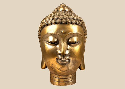 Mid-20th-century cast copper-alloy Buddha head sculpture featuring a serene expression, spiral hair curls, elongated earlobes, and a warm golden finish.