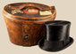 Antique British black silk top hat by Scott & Co. of London, accompanied by its original brown leather travelling case.
