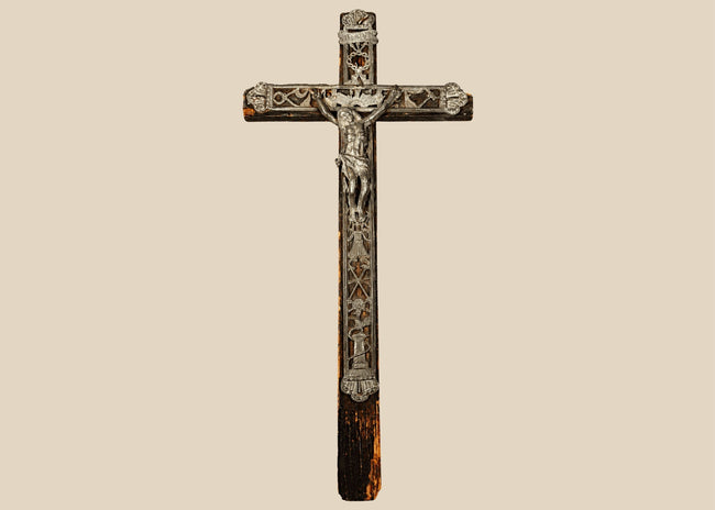 18th-century French peddler’s crucifix with embossed lead religious figures mounted on a dark-painted pine wooden cross.