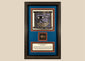 Ancient Egyptian Eye of Horus amulet dating to 663–304 BCE, mounted in an ornate framed historical display.