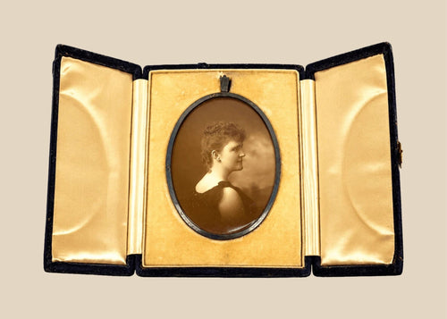 Late Victorian sepia photographic portrait of a woman displayed in an open black velvet folding presentation case, circa 1895–1915.