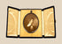 Late Victorian sepia photographic portrait of a woman displayed in an open black velvet folding presentation case, circa 1895–1915.