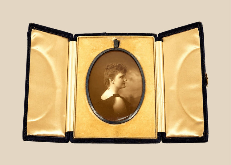 Late Victorian sepia photographic portrait of a woman displayed in an open black velvet folding presentation case, circa 1895–1915.