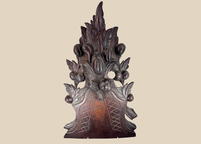 Antique European Black Forest-style carved wood furniture crest with overflowing fruit basket, foliage and deep reddish-brown patina