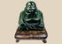 Chinese carved dark green hardstone Budai Laughing Buddha figure on fitted hardwood stand