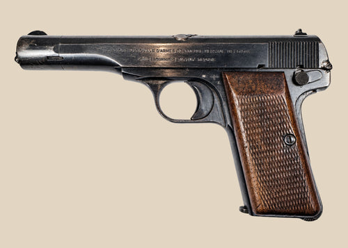 Deactivated WWII FN Browning Model 1922 pistol with worn blued steel and checkered walnut grips against a beige background.