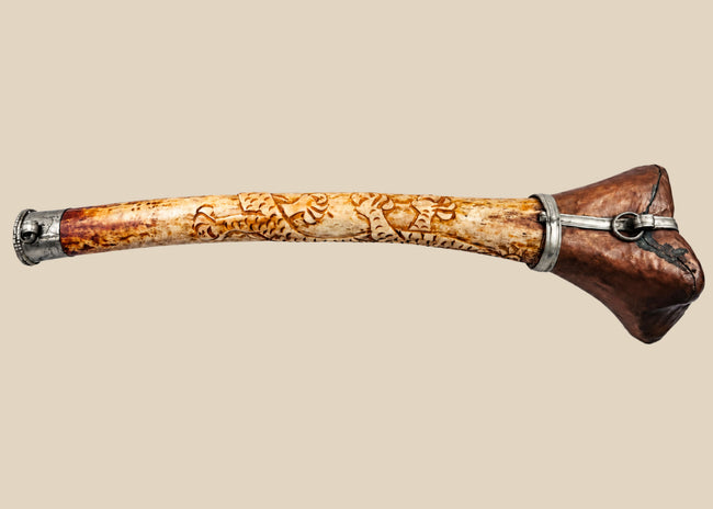 Antique Tibetan kangling ritual trumpet made from human femur bone with carved dragon decoration and metal fittings