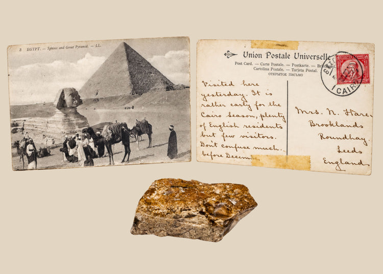 Historic Giza travel grouping with a limestone fragment reportedly collected from the Great Pyramid and an early 20th-century Egyptian postcard.