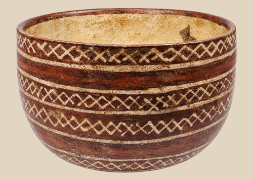 Red-brown ceramic bowl with cream interlocking diamond patterns and horizontal bands