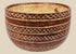 Red-brown ceramic bowl with cream interlocking diamond patterns and horizontal bands