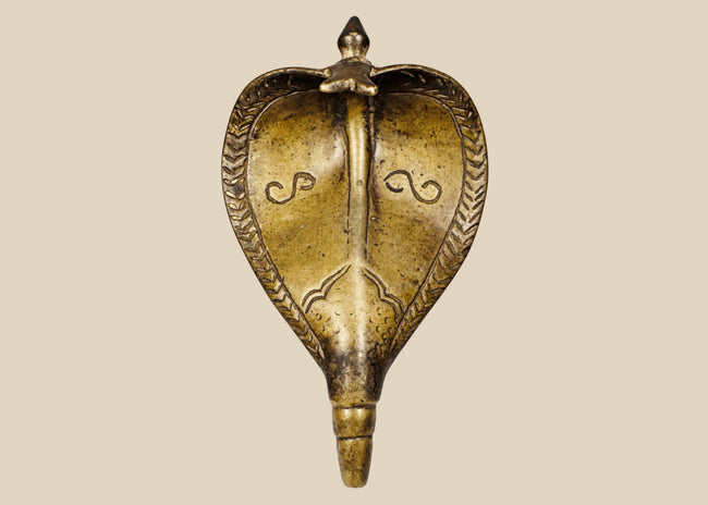 Antique 19th century Indian brass Naga cobra shrine canopy with expanded hood and aged patina.