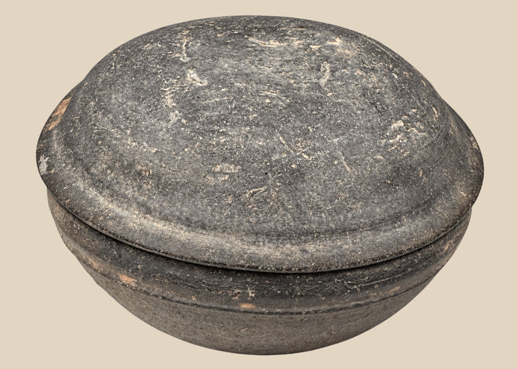 Ancient Chinese gray pottery covered bowl attributed to the Tang Dynasty, shown closed with shallow domed lid and aged earthenware surface.