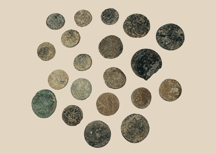 Collection of twenty ancient Roman and Late Antique bronze coins with varied sizes, irregular flans, and green-brown archaeological patina.