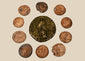 Collection of 10 ancient Roman bronze and copper-alloy coins, circa 3rd–4th century CE, with varied imperial portraits and aged patina.