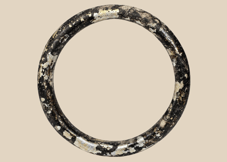 Ancient Roman dark glass bracelet with heavy iridescent burial weathering, circa 2nd–4th century CE