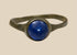 Ancient Roman bronze finger ring with round deep blue glass cabochon, circa 2nd–4th century CE