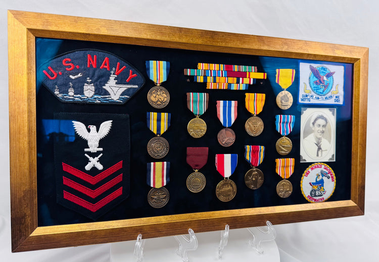Framed naval military collection including USS Norris patch, rank insignia, and campaign medals