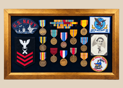 Framed U.S. Navy veteran shadow box featuring medals, patches, ribbon bars, and portrait photograph