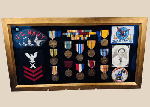 Framed U.S. Navy veteran shadow box featuring medals, patches, ribbon bars, and portrait photograph