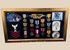 Framed U.S. Navy veteran shadow box featuring medals, patches, ribbon bars, and portrait photograph