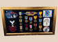 Framed U.S. Navy veteran shadow box featuring medals, patches, ribbon bars, and portrait photograph