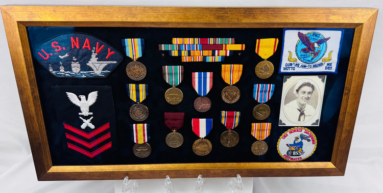 United States Navy veteran memorial display with photograph, awards, and embroidered emblems