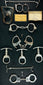 Antique handcuffs, keys, and leather pouch from a framed 19th–20th century restraint collection displayed on black fabric background.