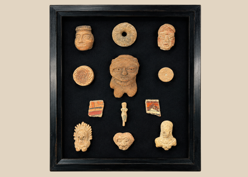 Framed collection of Pre-Columbian terracotta artifacts displayed on a black background