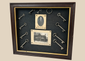 Framed 19th-century display with eleven iron keys, portrait of night watchman Hugh Newell, and early photograph of T. McCormick’s 1867 factory, preserved in a wooden shadowbox.