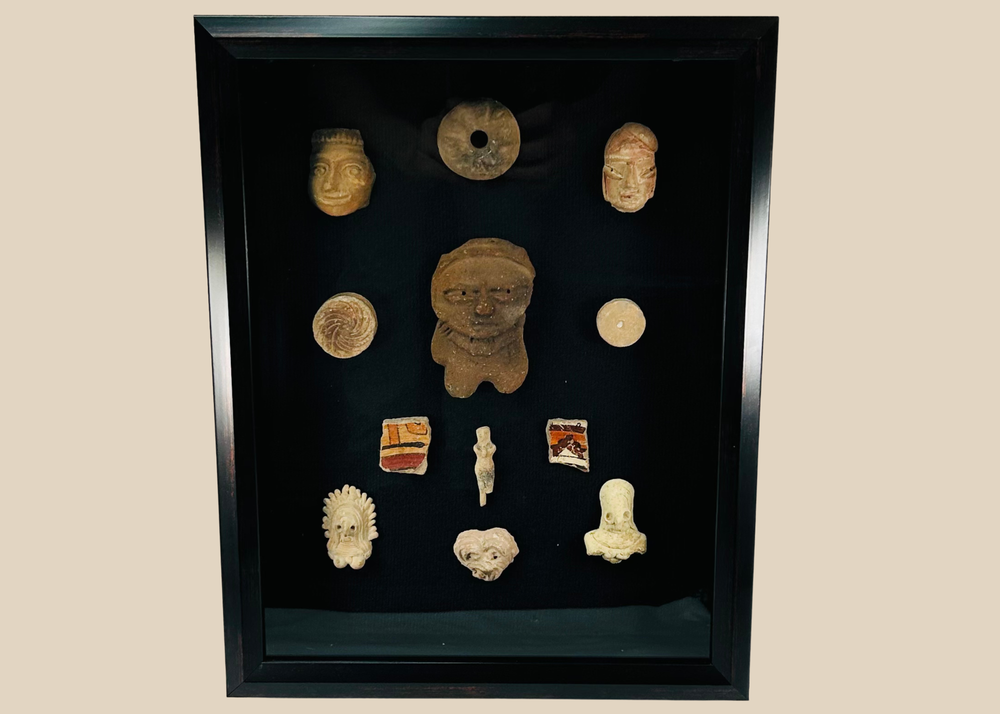 Framed collection of Pre-Columbian terracotta artifacts displayed on a black background