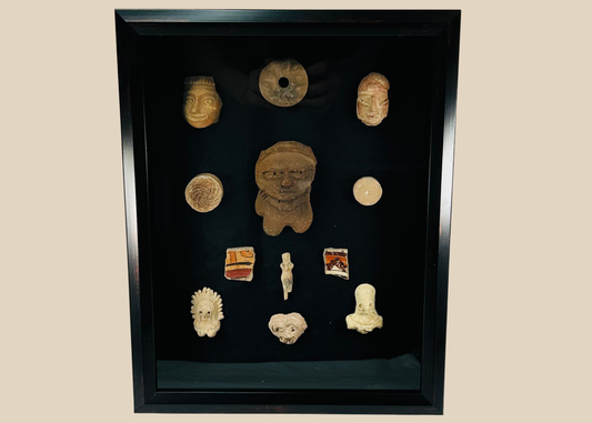 Framed collection of Pre-Columbian terracotta artifacts displayed on a black background
