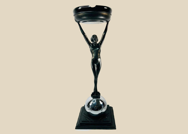 Rare Art Deco smoking stand, circa 1925–1935, attributed to Frankart Inc. New York. Features nude female figure with raised arms supporting circular tray, original patinated finish, and stepped Deco base. Iconic Jazz Age decorative design.