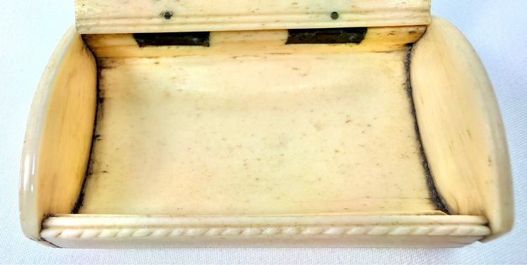 French prisoner-of-war bone snuff box featuring deeply incised Masonic iconography and decorative rope-pattern edging.