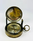 Museum-style photograph of a French pocket compass used as an early 20th-century navigation instrument.
