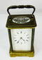 Antique French carriage clock by Jules Bunelot with brass case and beveled glass panels.