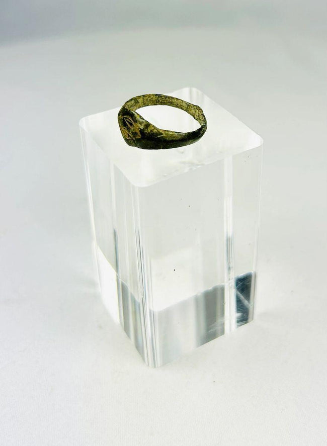 Side view of Roman bronze signet ring showing tapered band and aged patina.