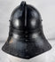 Collectible seventeenth-century forged iron armour helmet from Northern Europe with aged black painted surface.