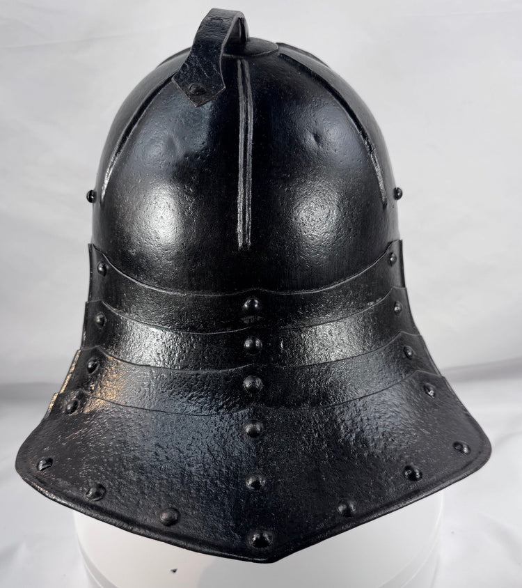 Collectible seventeenth-century forged iron armour helmet from Northern Europe with aged black painted surface.