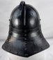 Collectible seventeenth-century forged iron armour helmet from Northern Europe with aged black painted surface.