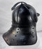 Rare Northern European forged iron combat helmet featuring rolled borders, ring finial, and articulated neck defense.