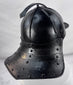 Rare Northern European forged iron combat helmet featuring rolled borders, ring finial, and articulated neck defense.