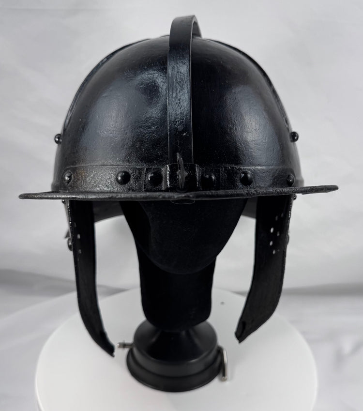 Seventeenth-century German or Dutch forged iron helmet featuring radiating flutes and original ring finial.